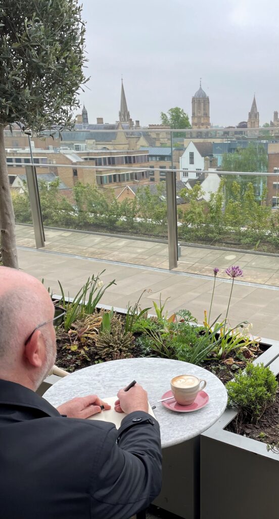 Craig sat in a cafe looking out over Oxford