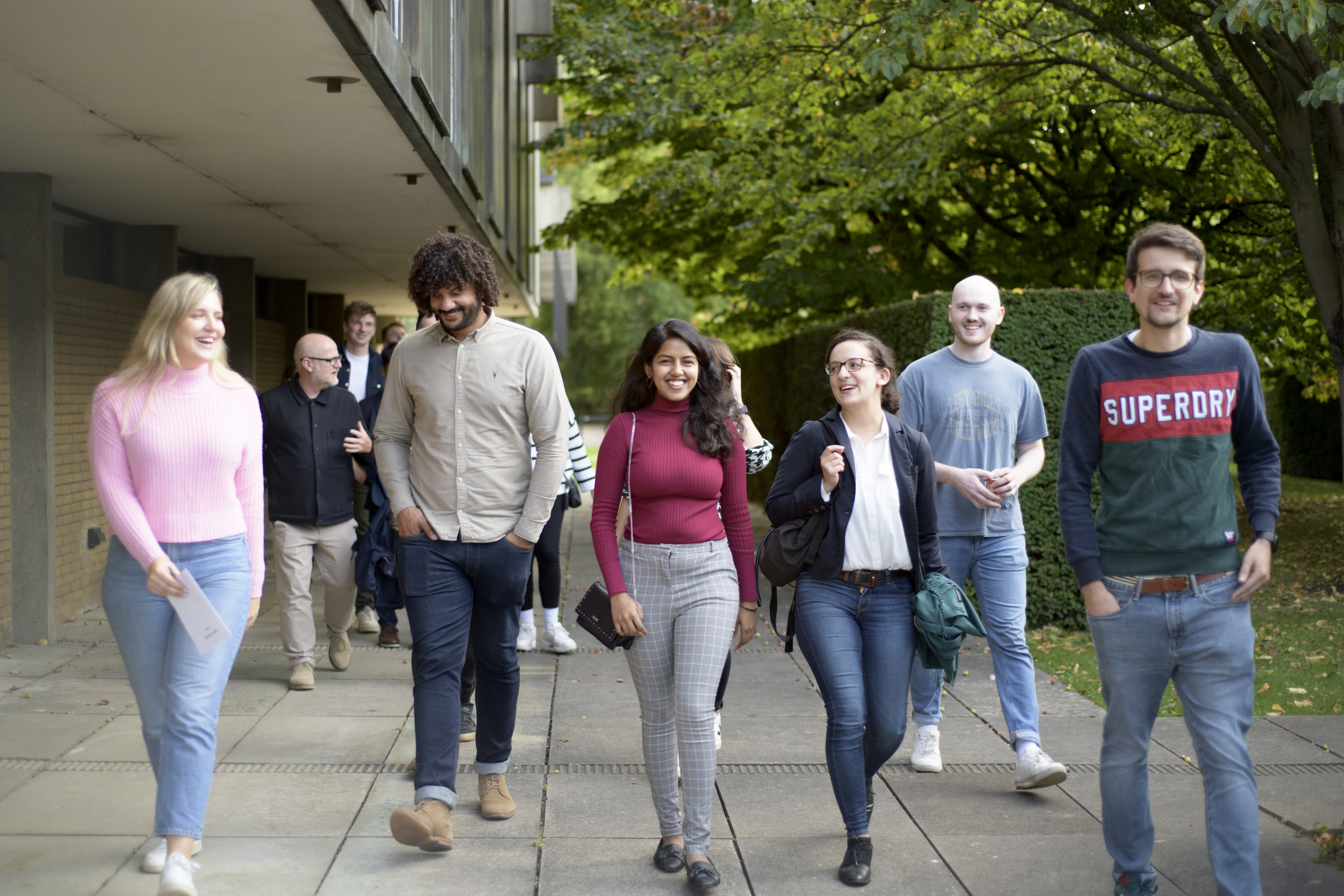 Staff at practice event walking through the grounds of St Catherine's College, Oxford